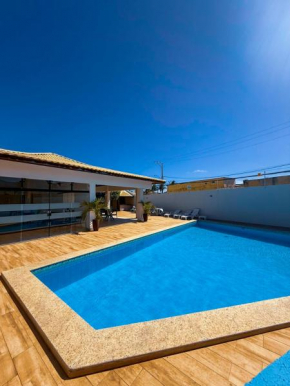 230m da PRAIA, casa com ESPAÇO GOURMET e CHURRASQUEIRA, Portaria 24h, 2 VAGAS de GARAGEM, acomoda até 10 PESSOAS, Próximo a MERCADOS e FARMÁCIA
